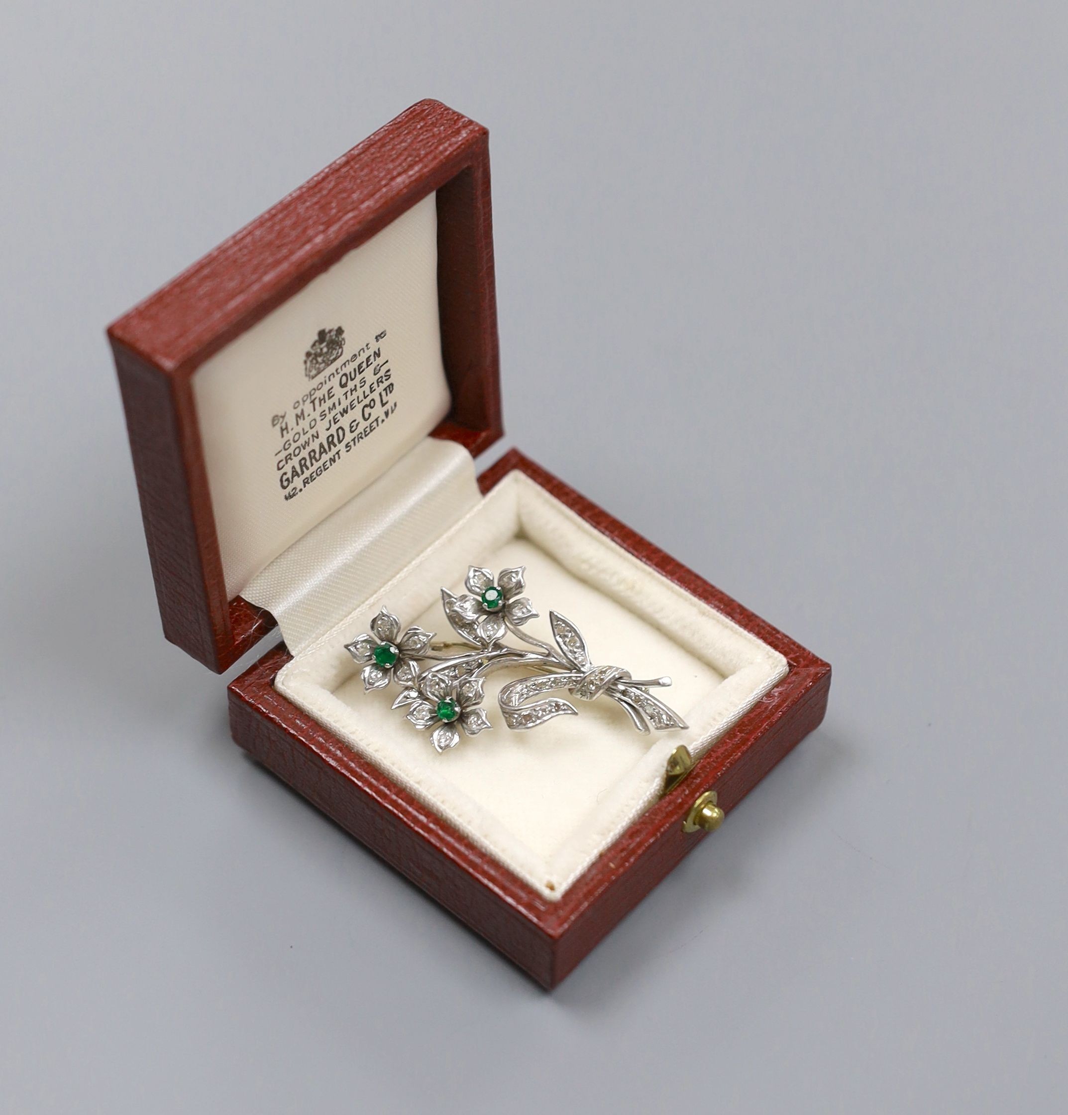 A 20th century white metal, emerald and diamond set spray brooch, 45mm, gross 10 grams.